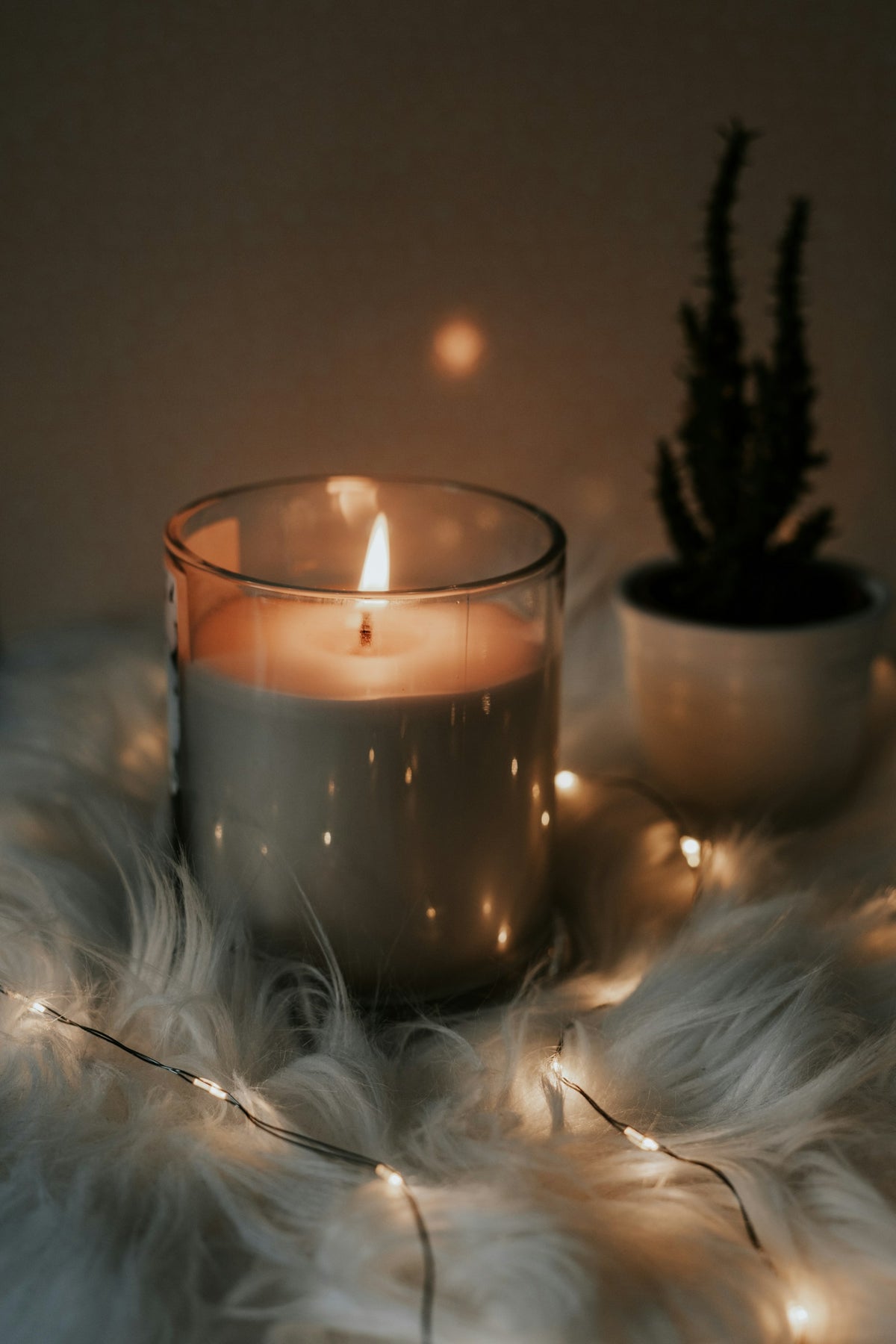 Lit scented candle with fairy lights